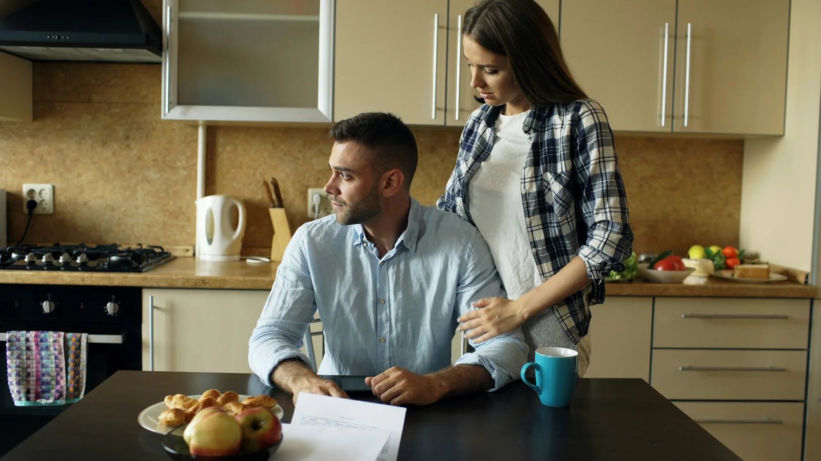 A homeowner reviewing a difficult financial decision with their partner